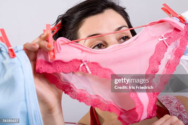 a woman hanging underwear on a clothesline - culotte sur la tête photos et images de collection