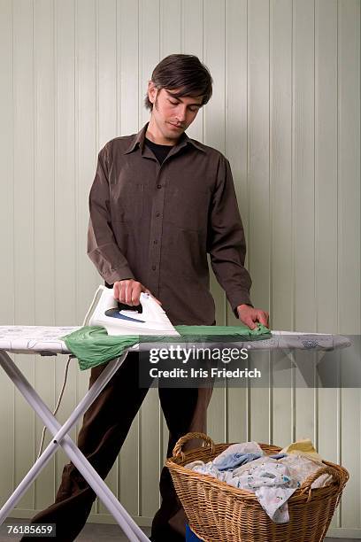 a man ironing - huisman stockfoto's en -beelden