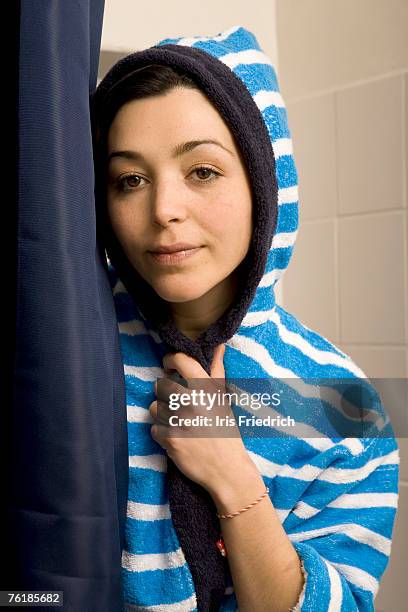 portrait of a woman wearing a striped bathrobe - frottee stock-fotos und bilder