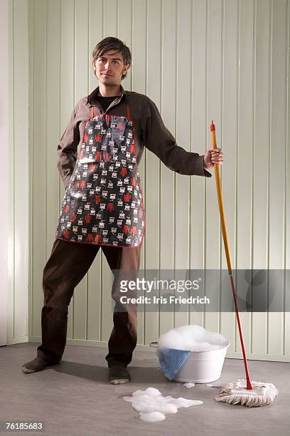 a man standing with a mop and bucket - daily bucket foto e immagini stock