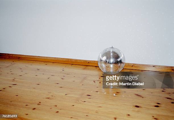 mirrored disco ball on a hardwood floor - silver disco ball stock pictures, royalty-free photos & images
