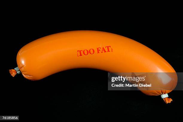 a sausage wrapped in plastic packaging and stamped 'too fat' - mystery meat stock pictures, royalty-free photos & images