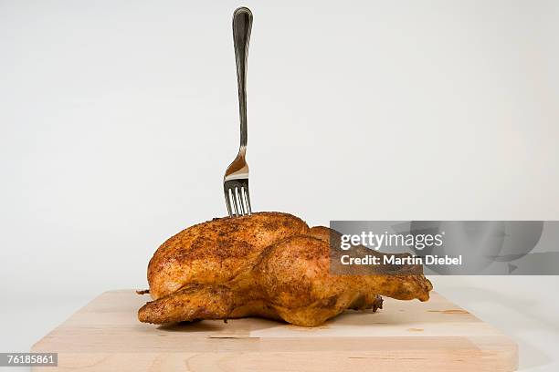 a fork stuck in a roast chicken - mystery meat stock pictures, royalty-free photos & images