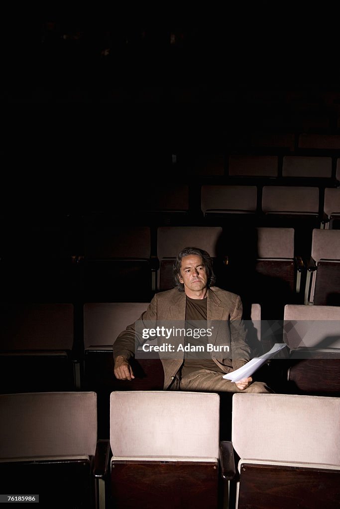 A director sitting in a theater