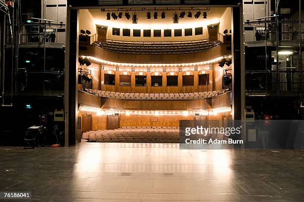 view of an illuminated art deco theater from backstage - kulisse bühne stock-fotos und bilder