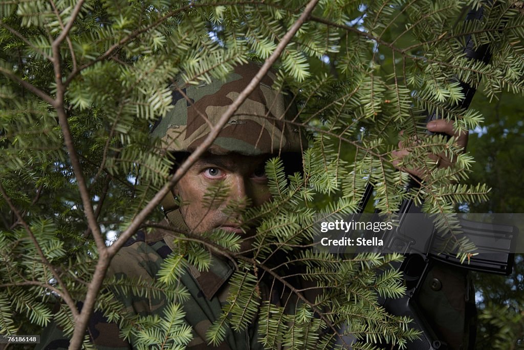 Soldier hiding behind a tree