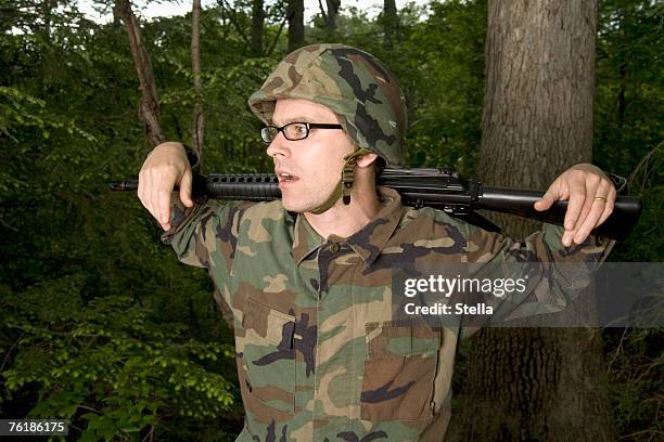 soldier resting a gun across his shoulders - army helmet stock pictures, royalty-free photos & images