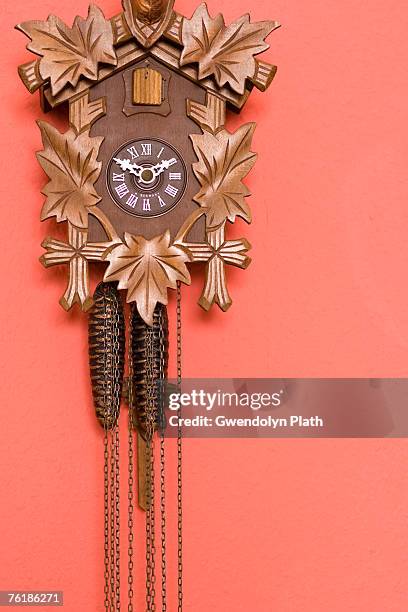 a cuckoo clock on a wall - kuckucksuhr stock-fotos und bilder