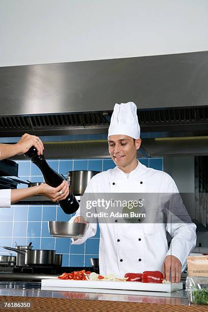 chefs working in a kitchen - adding pepper stock pictures, royalty-free photos & images