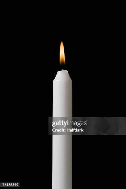 a burning candle - candle flame stockfoto's en -beelden