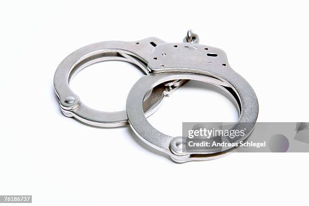 a pair of handcuffs - handcuffs imagens e fotografias de stock