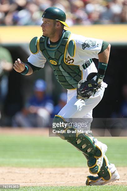 Rob Bowen of the Oakland Athletics chases a bunt down the third base line during the game against the Kansas City Royals at McAfee Coliseum in...