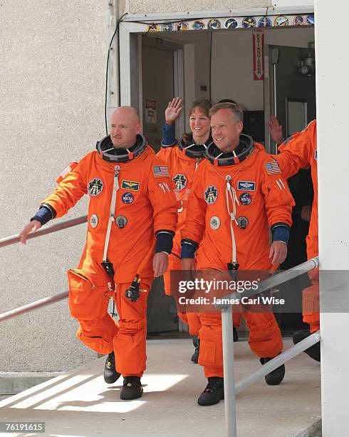 Pilot Mark Kelly, mission specialists Thomas Reiter, Mike Fossum and Commander Steve Lindsey leave crew quarters enroute to the launch pad 39B for...