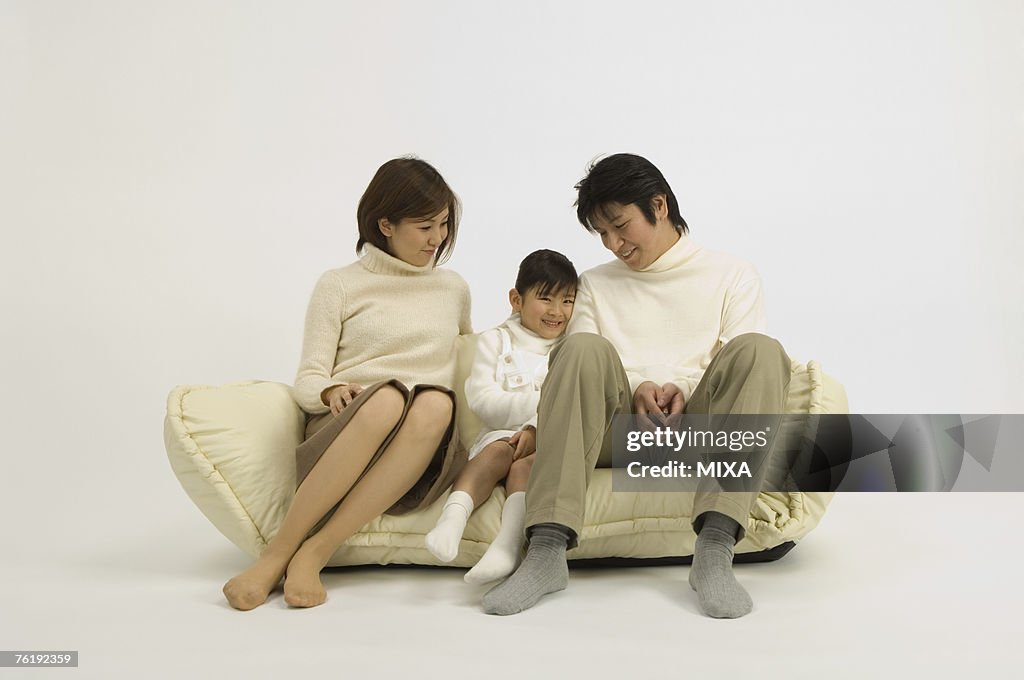 Family sitting on sofa