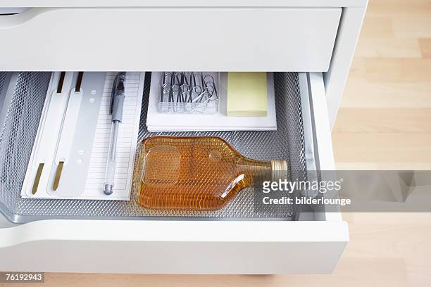view into open desk drawer containing small alcohol bottle - fickplunta bildbanksfoton och bilder