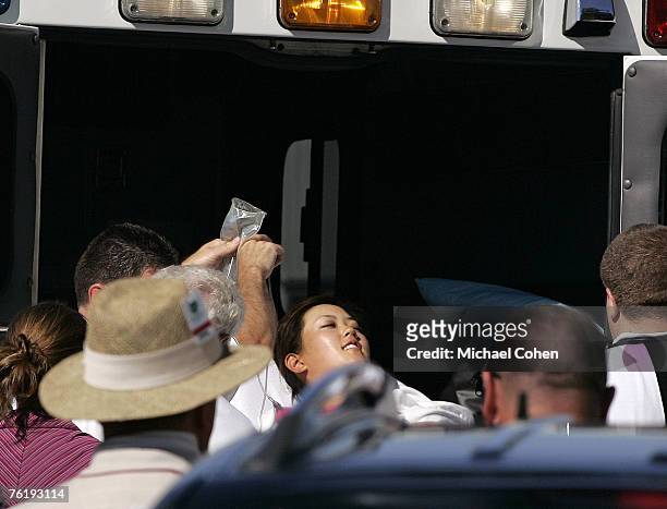 Michelle Wie is placed in an ambulance during the second round of the John Deere Classic at TPC Deere Run in Silvis, Illinois on July 14, 2006. Wie...