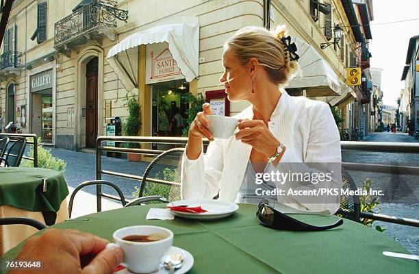 woman taking coffee at outdoor cafe, venice, veneto, italy, europe - venice italy stock-fotos und bilder