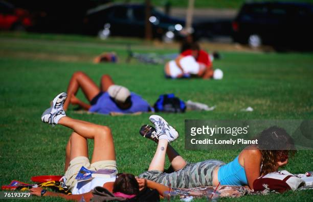 relaxing on the grass in dolores park, mission district, san francisco, california, united states of america, north america - dolores park fotografías e imágenes de stock