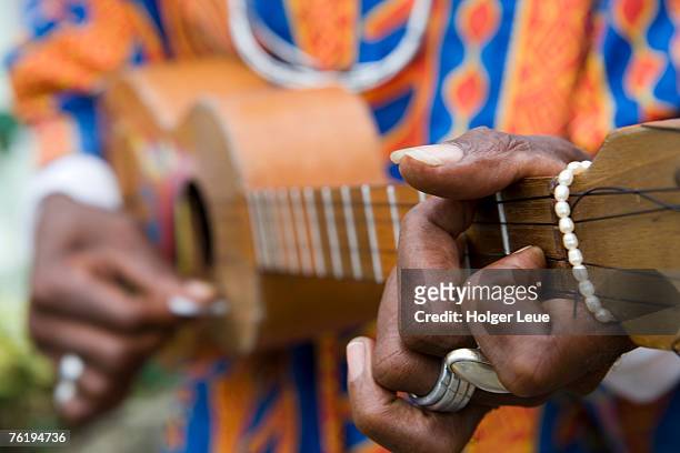 man playing caribbean mandolin, grand etang forest reserve visitor centre,  grand etang national park, st george, grenada, central america & the caribbean - caribbean musical instrument stock pictures, royalty-free photos & images