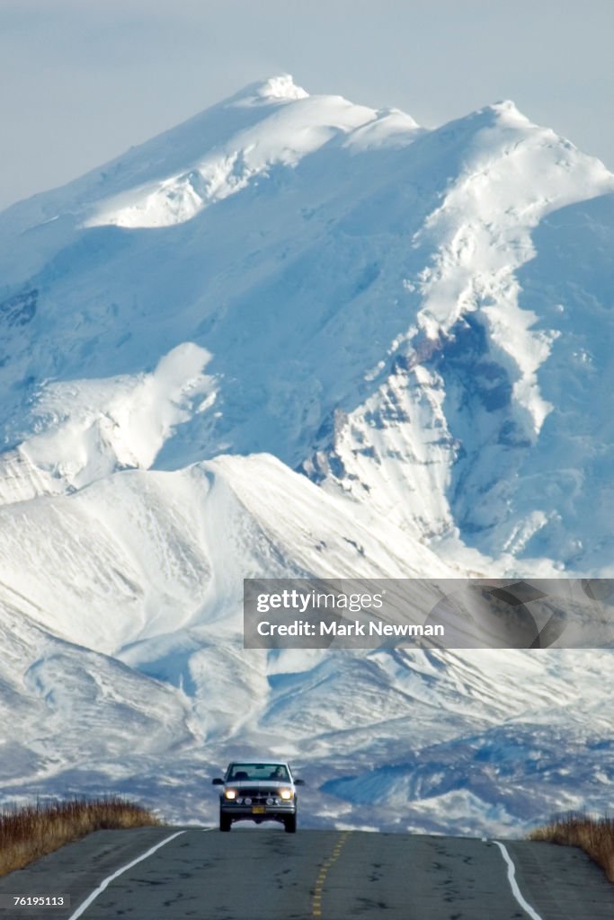 Car on highway with Mt, Drum in background, Wrangell-St Elias National Park, Alaska, United States of America, North America