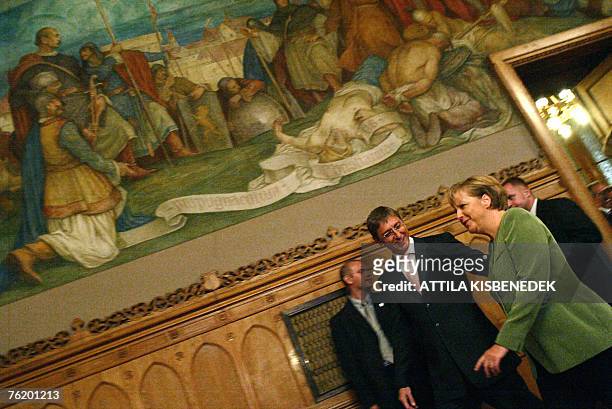Hungarian Prime Minister Ferenc Gyurcsany and German Chancellor Angela Merkel arrive for a meeting at the Nandorfehervari Hall of the parliament...