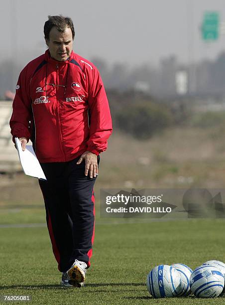 Argentine Marcelo Bielsa, coach of the Chilean national football team, looks at the balls during a training session in Santiago, 21 August 2007....
