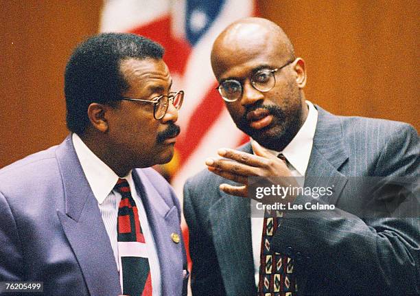 Defense attorney Johnnie Cochran and deputy district attorney Christopher Darden confer during testimony in the O.J. Simpson murder trial on June 15,...