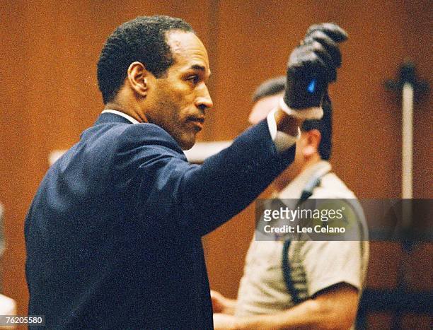 Simpson shows the jury a leather glove allegedly used in the murders of Nicole Brown Simpson and Ronald Goldman during testimony in Simpson's murder...