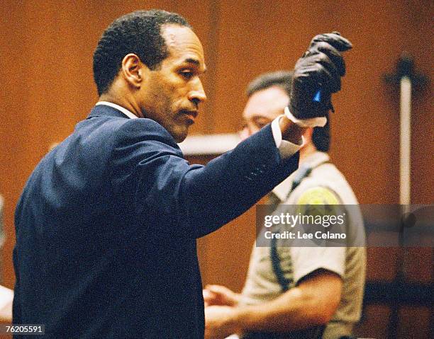 Simpson shows the jury a leather glove allegedly used in the murders of Nicole Brown Simpson and Ronald Goldman during testimony in Simpson's murder...