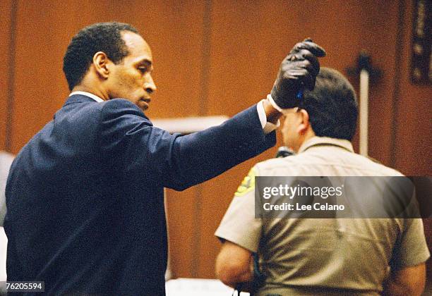 Simpson shows the jury a leather glove allegedly used in the murders of Nicole Brown Simpson and Ronald Goldman during testimony in Simpson's murder...