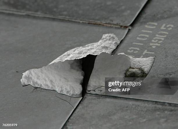 View of the damaged tiles on the underbelly of the space shuttle Endeavour following landing, 21 August 2007, at Kennedy Space Center in Cape...