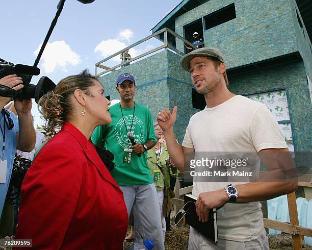 Brad Pitt and council member Cynthia Willard-Lewis attend a press conference for the Global Green USA's first house project at the Holy Cross...