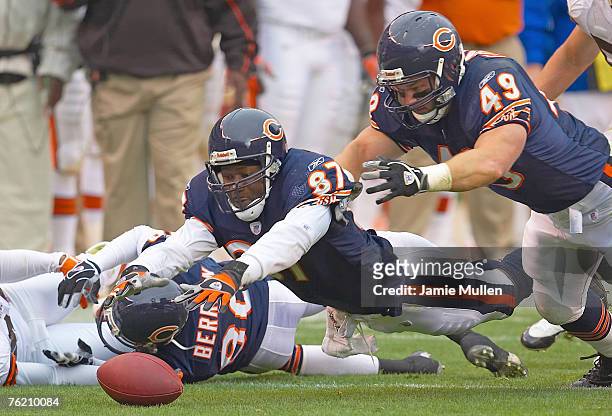 Chicago Bears' Muhsin Muhammad and Marc Edwards dive toward the ball fumbled by teammate Bernard Berrian during the game against the Cleveland...