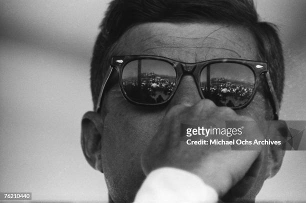 President John F. Kennedy reflects the crowd in his Ray Ban sunglasses during the groundbreaking ceremony for the Dan Luis Dam on August 18, 1962 on...