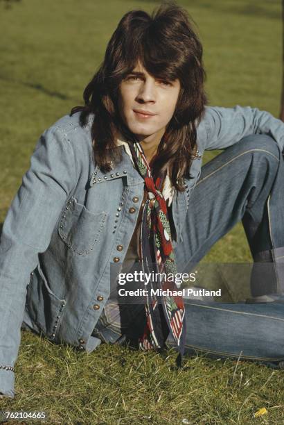 Australian singer-songwriter Rick Springfield pictured wearing a denim jacket and jeans with tied neckerchief scarf in London in 1973.