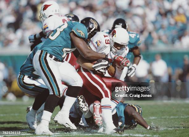 MarTay Jenkins, Wide Receiver for the Arizona Cardinals is tackled by Jermaine Williams during the American Football Conference Central game against...