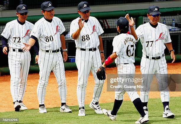 Japanese baseball team's manager Senichi Hoshino and coaches Koichi Tabuchi , Koji Yamamoto and Yutaka Ono celebrates with their player Jun Ohtsuka...