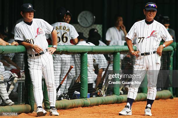 Japanese baseball team's manager Senichi Hoshino and coach Koji Yamamoto watch their players warming up ahead a match against France in the Good Luck...