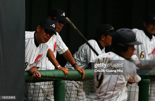 Japanese baseball team manager Senichi Hoshino and coach Koichi Tabuchi watch a match against France in the Good Luck Beijing baseball tournament at...