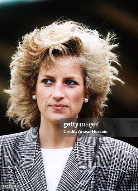 Diana, Princess of Wales, wearing a check blazer, looks windswept as she attends the Burghley Horse Trials on September 10, 1989 in Stamford, United...