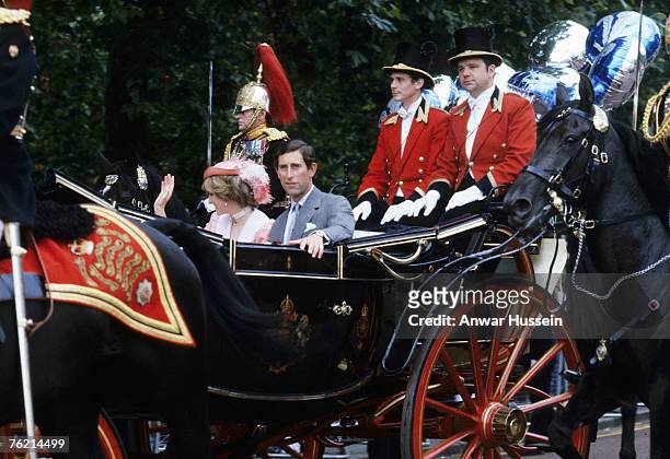 Prince Charles, Prince of Wales and Diana, Princess of Wales, wearing a peach coloured dress with a white collar designed by Bellville Sassoon, a...