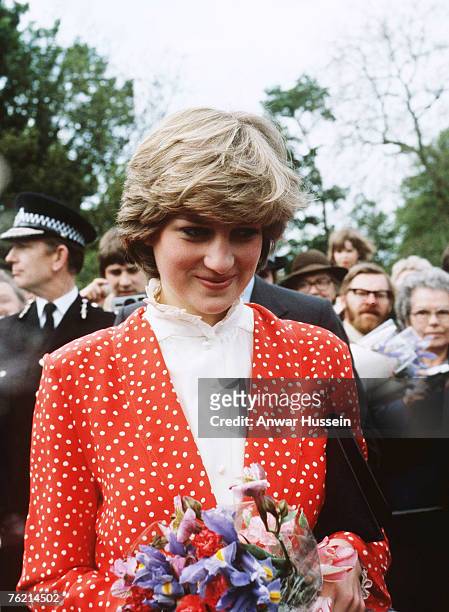 Lady Diana Spencer, wearing a red and white polka dot suit designed by Jasper Conran, attends her first walkabout with her fiance Prince Charles,...