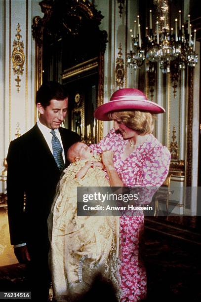 Diana, Princess of Wales holds baby Prince William as Prince Charles, Prince of Wales looks on during the christening of Prince William in the Music...