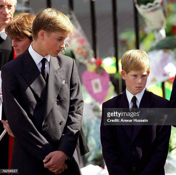 Prince William and Prince Harry stand outside Westminster Abbey at the funeral of Diana, Princess of Wales on September 6, 1997 in London, England.