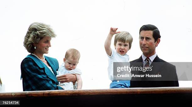 Prince Charles, Prince of Wales, Princess Diana, Princess of Wales, wearing a green coat designed by David and Elizabeth Emanuel, pose with sons...
