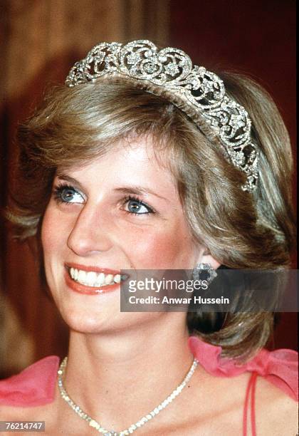 Diana, Princess of Wales, wearing a pink dress designed by Victor Edelstein, the Spencer family tiara and diamond and sapphire jewels given to her by...