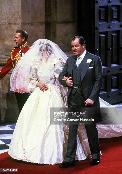 Lady Diana Spencer, wearing a wedding dress designed by David and Elizabeth Emanuel and the Spencer family Tiara, enters St. Paul's Cathedral on the...