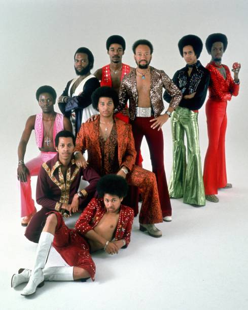 Group Earth Wind & Fire pose for a studio portrait circa the mid 1970s.