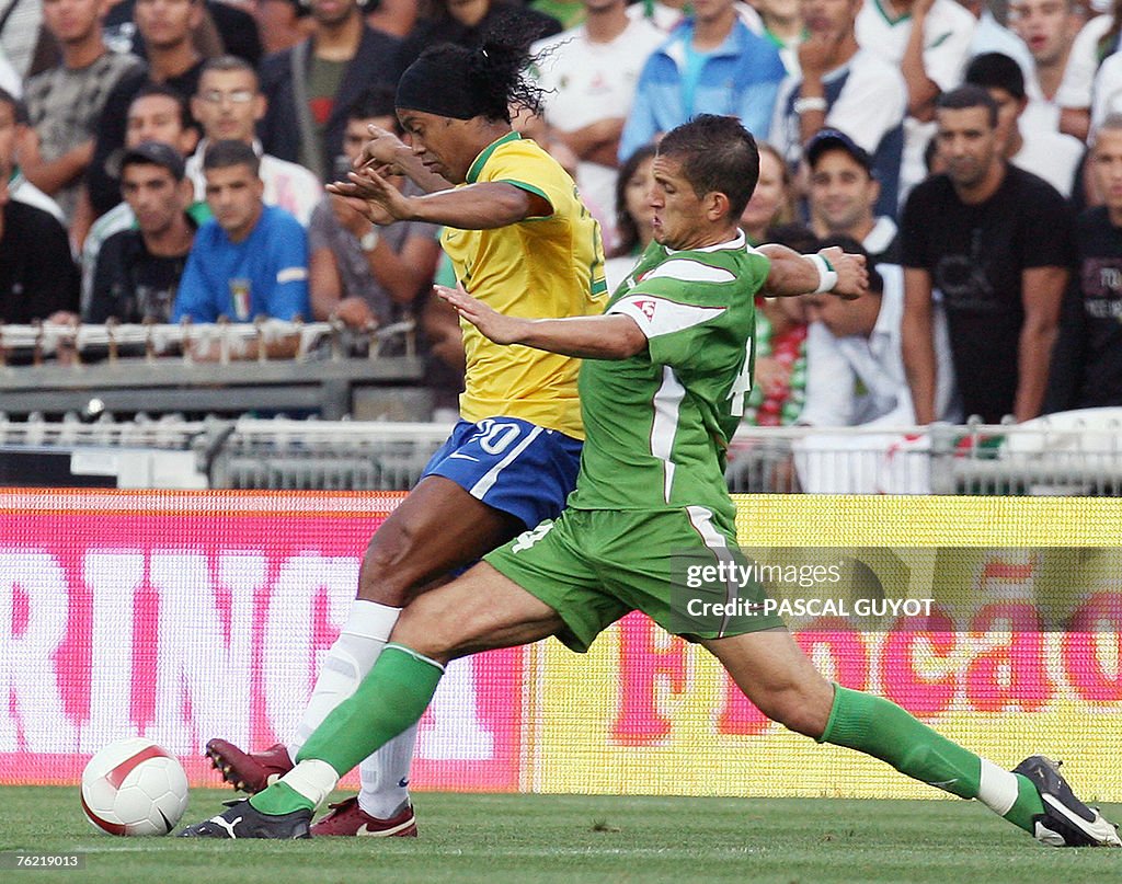 Brazil's forward Ronaldinho (L) vies wit