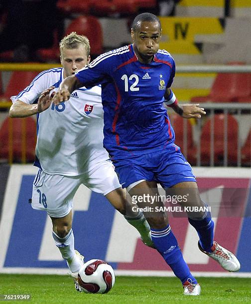 Slovakia's Marek Sapara vies with France's striker Thierry Henry during their friendly Euro 2008 football match, 22 August 2007 in Trnava. AFP PHOTO...